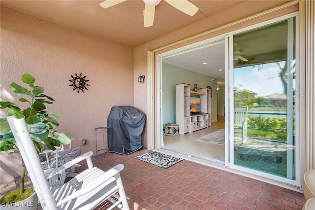 view of patio / terrace with ceiling fan and a grill