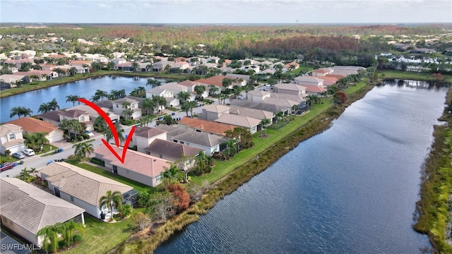 birds eye view of property with a water view