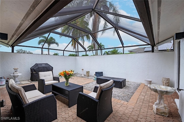 view of patio with a grill, an outdoor living space, and glass enclosure