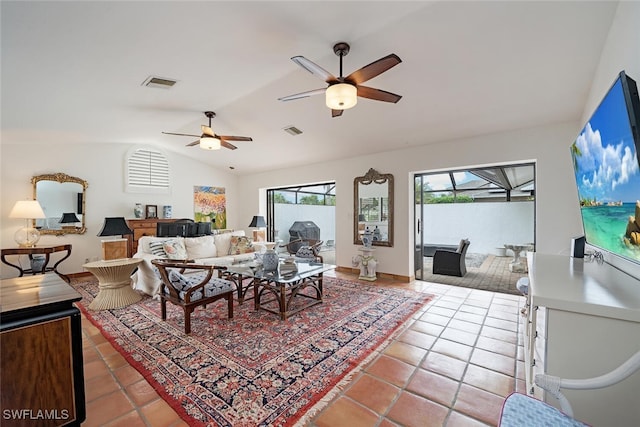 tiled living room with ceiling fan and vaulted ceiling