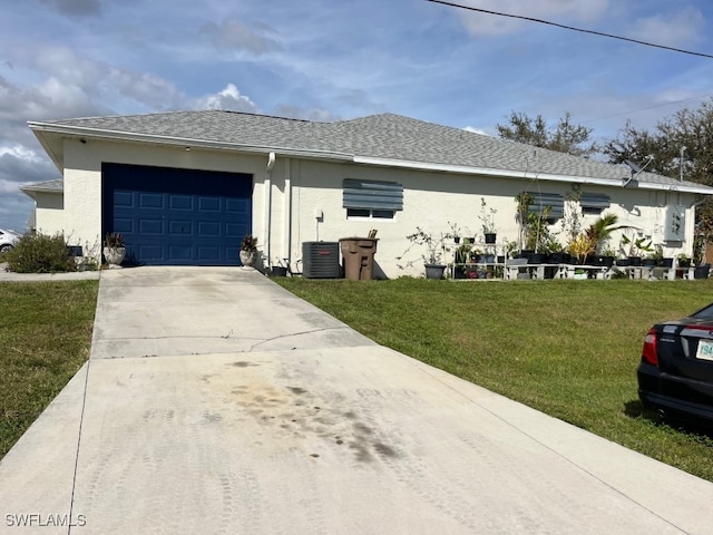 view of side of property featuring a garage, cooling unit, and a lawn