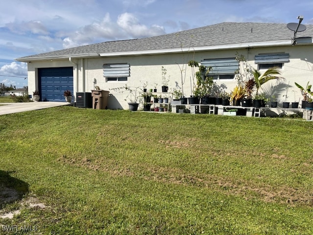 exterior space featuring a lawn and a garage