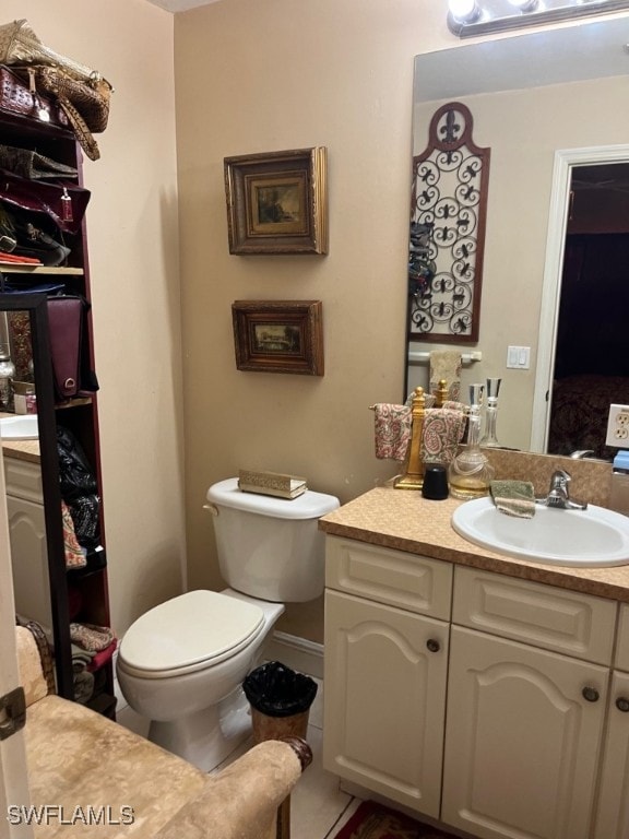 bathroom with vanity, tile patterned floors, and toilet