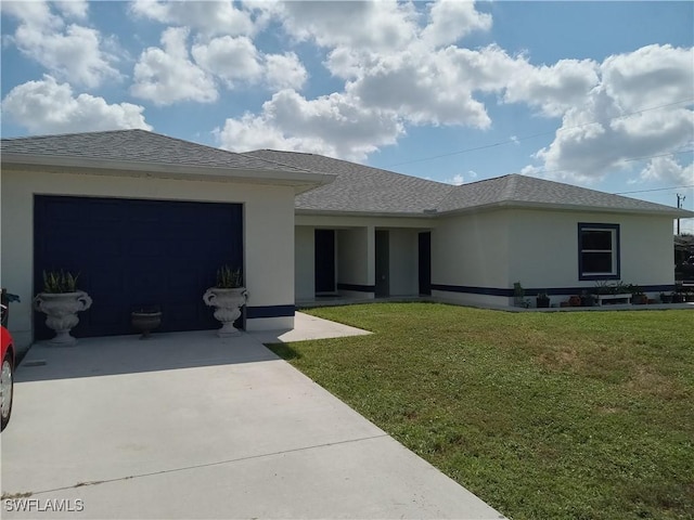 view of front of home featuring a garage and a front lawn