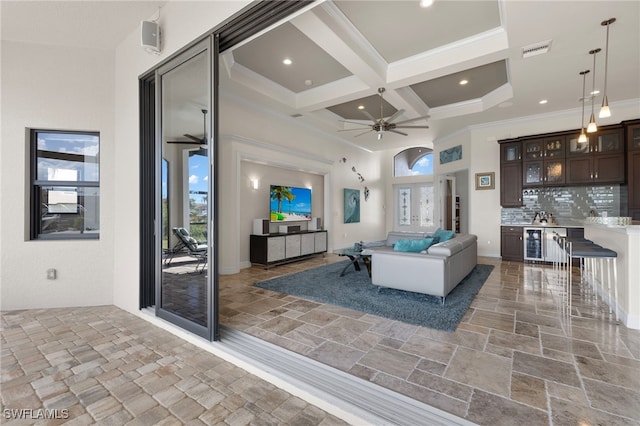 living room with crown molding, coffered ceiling, beamed ceiling, and a wealth of natural light