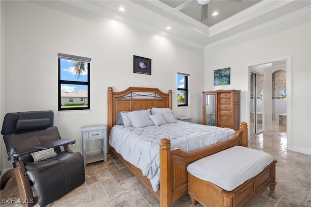 bedroom with ceiling fan, crown molding, and a high ceiling