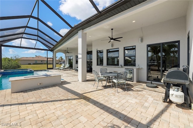 view of patio / terrace featuring wine cooler, a lanai, grilling area, and ceiling fan