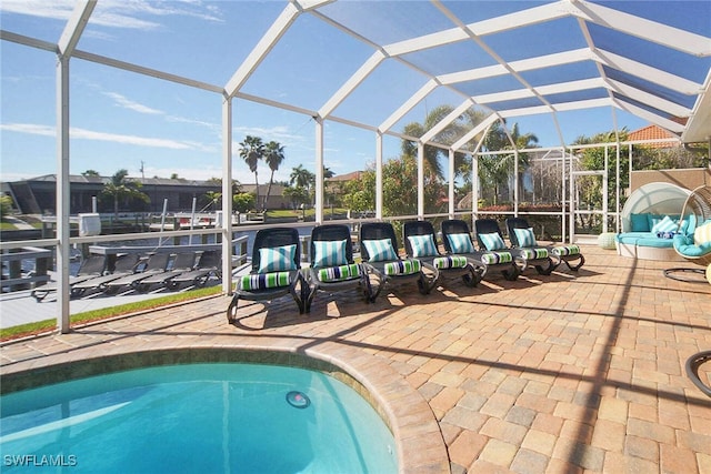 view of swimming pool featuring a patio area and glass enclosure