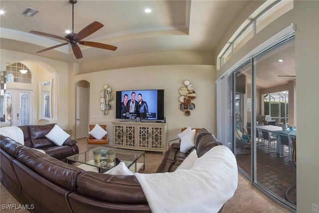 living room featuring ornamental molding, carpet flooring, and ceiling fan