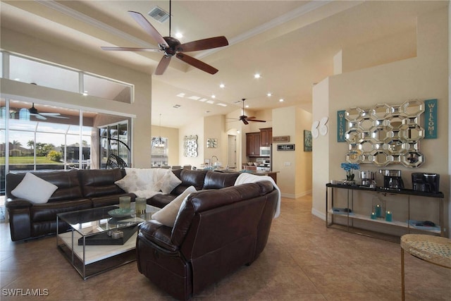 living room with crown molding, a high ceiling, and tile patterned flooring