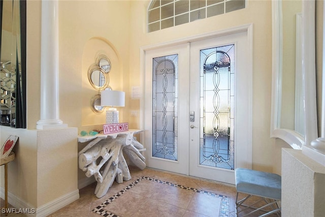 tiled entryway with french doors and ornate columns