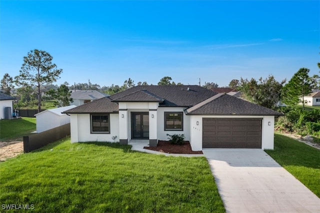 view of front of home featuring a front lawn and a garage