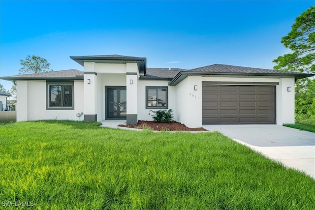 view of front of property with a front lawn and a garage