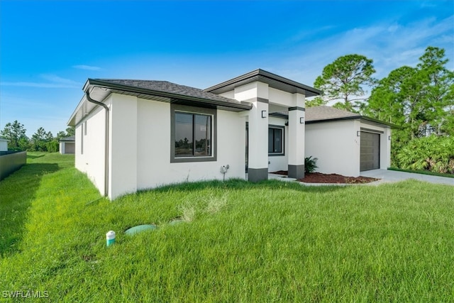 view of front of property featuring a garage and a front lawn