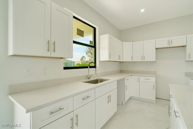 kitchen with sink and white cabinetry