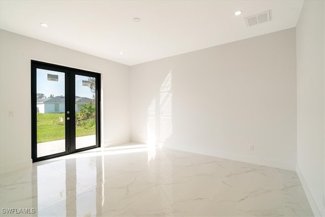 unfurnished room with french doors