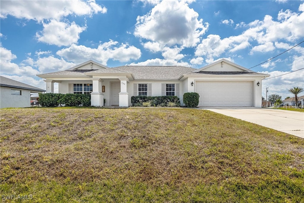 view of front of house with a front yard and a garage