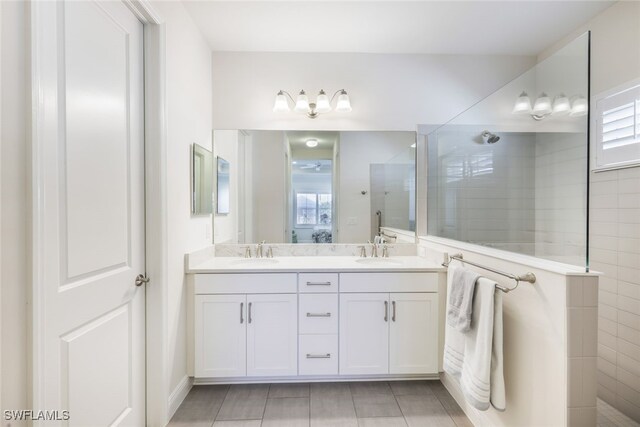 bathroom featuring vanity and tiled shower