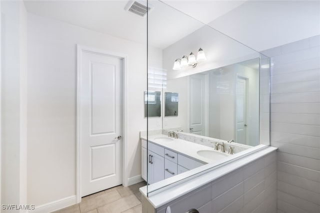 bathroom featuring tile patterned flooring and vanity