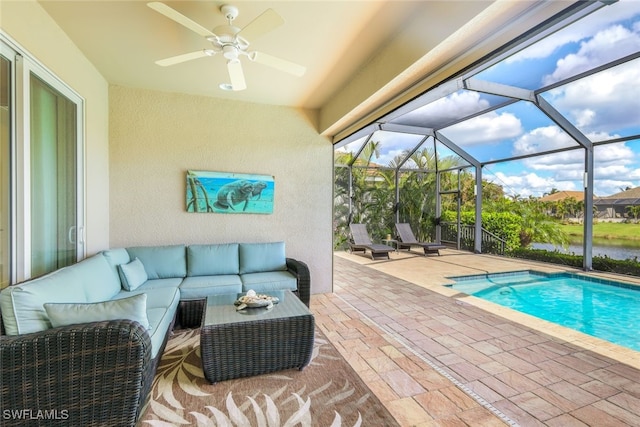 view of pool with ceiling fan, an outdoor hangout area, a patio, and glass enclosure