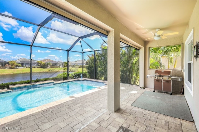 view of pool with area for grilling, ceiling fan, a patio area, and a water view