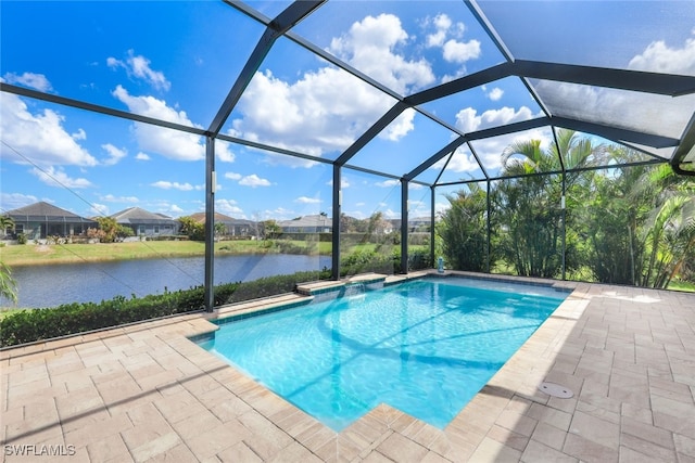 view of swimming pool featuring a patio, a water view, and glass enclosure