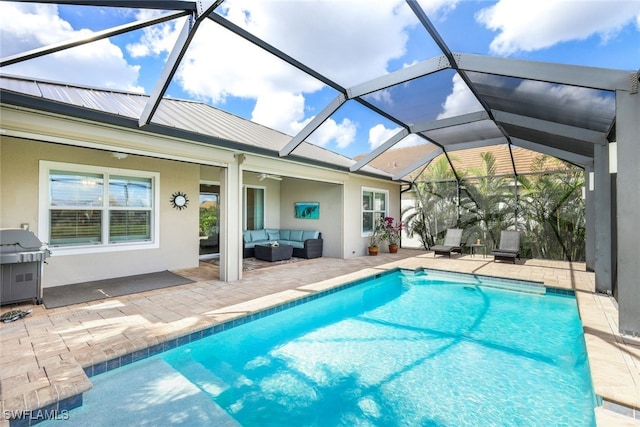 view of swimming pool featuring area for grilling, a lanai, an outdoor living space, ceiling fan, and a patio area