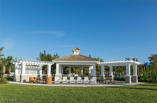 view of property's community featuring a pergola and a lawn