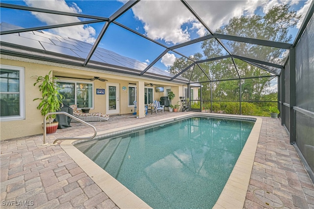 view of swimming pool with a lanai, a patio, and ceiling fan