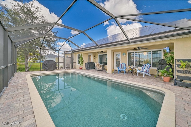 view of swimming pool with a patio, ceiling fan, and a lanai