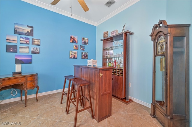 bar with ornamental molding, light tile patterned flooring, and ceiling fan