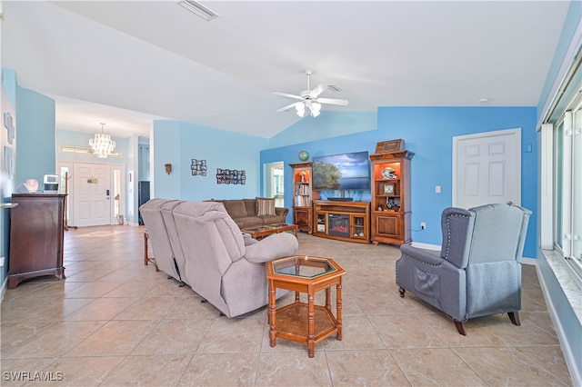 tiled living room with lofted ceiling, a wealth of natural light, and ceiling fan with notable chandelier