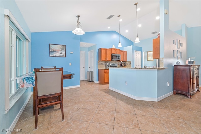 kitchen featuring kitchen peninsula, hanging light fixtures, backsplash, appliances with stainless steel finishes, and high vaulted ceiling