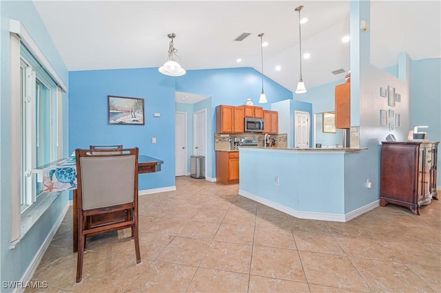 3922 NE 23rd Pl, Cape Coral, FL 33909 - kitchen featuring stainless steel microwave, tasteful backsplash, visible vents, hanging light fixtures, and baseboards