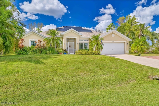 ranch-style house with a front yard, a garage, and solar panels