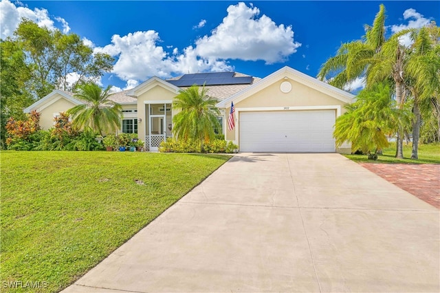 ranch-style home with solar panels, a front yard, and a garage