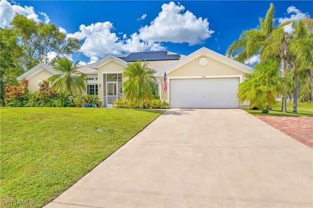 3922 NE 23rd Pl, Cape Coral, FL 33909 - single story home with driveway, an attached garage, stucco siding, a front lawn, and roof mounted solar panels