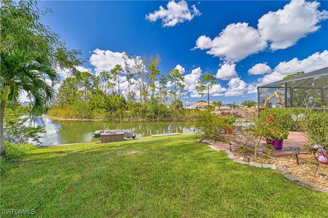 view of yard with a water view and a lanai