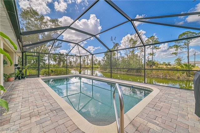 view of swimming pool featuring a patio, a water view, and a lanai