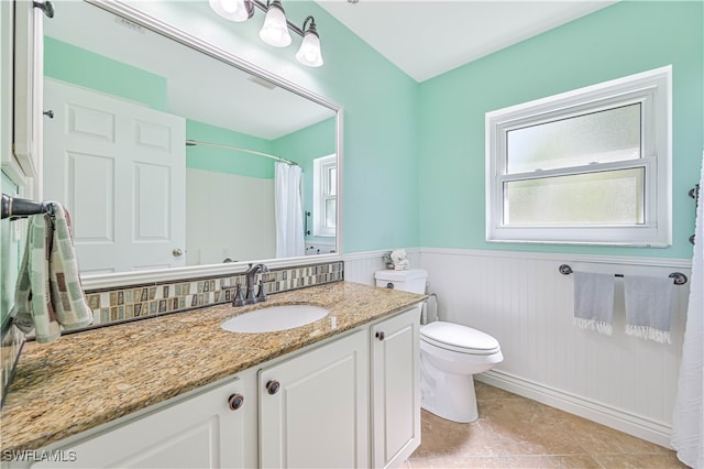 bathroom featuring vanity, curtained shower, toilet, and tile patterned floors