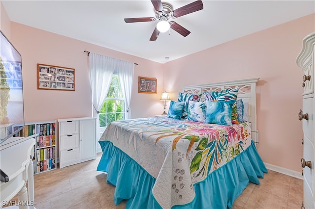 tiled bedroom featuring ceiling fan