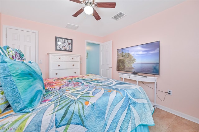 tiled bedroom featuring ceiling fan