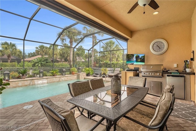 view of patio with glass enclosure, ceiling fan, a grill, pool water feature, and area for grilling