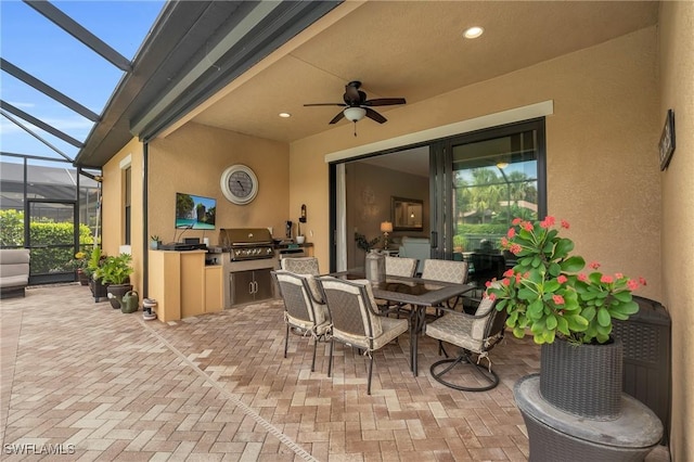 view of patio featuring ceiling fan, area for grilling, and a lanai