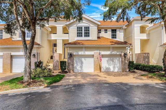 multi unit property featuring a garage