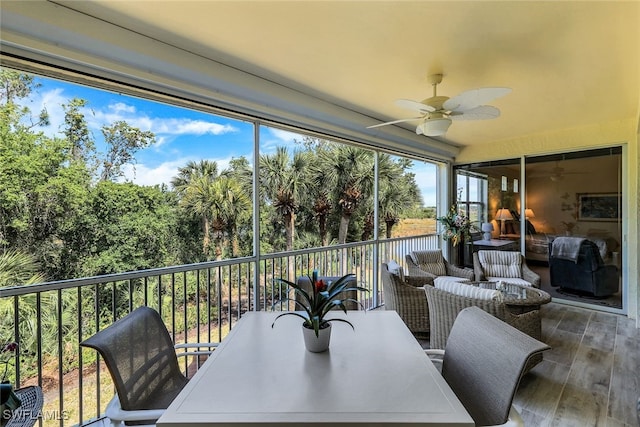 sunroom / solarium featuring ceiling fan