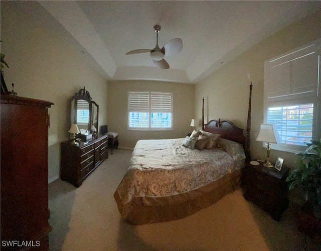 carpeted bedroom with ceiling fan and multiple windows