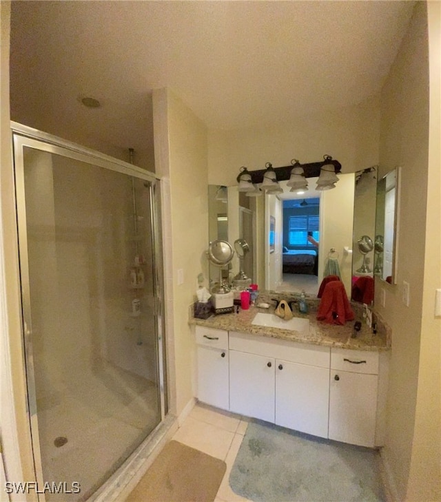 bathroom featuring tile patterned floors, vanity, and an enclosed shower