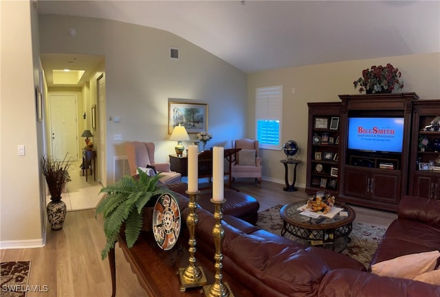 living room with light wood-type flooring and lofted ceiling