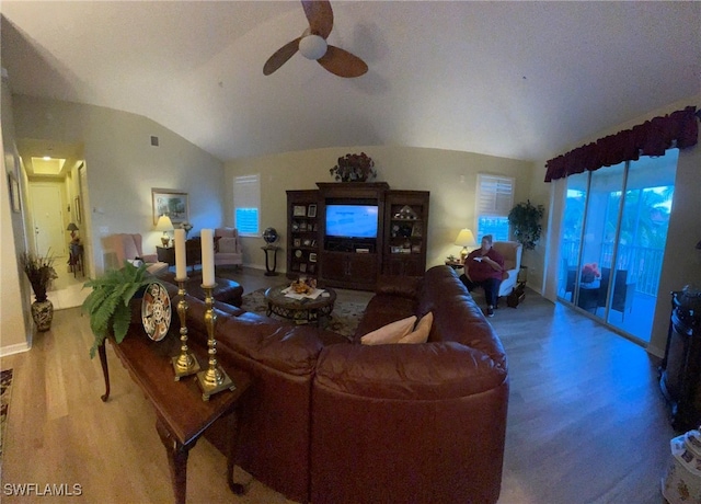 living room with ceiling fan and vaulted ceiling